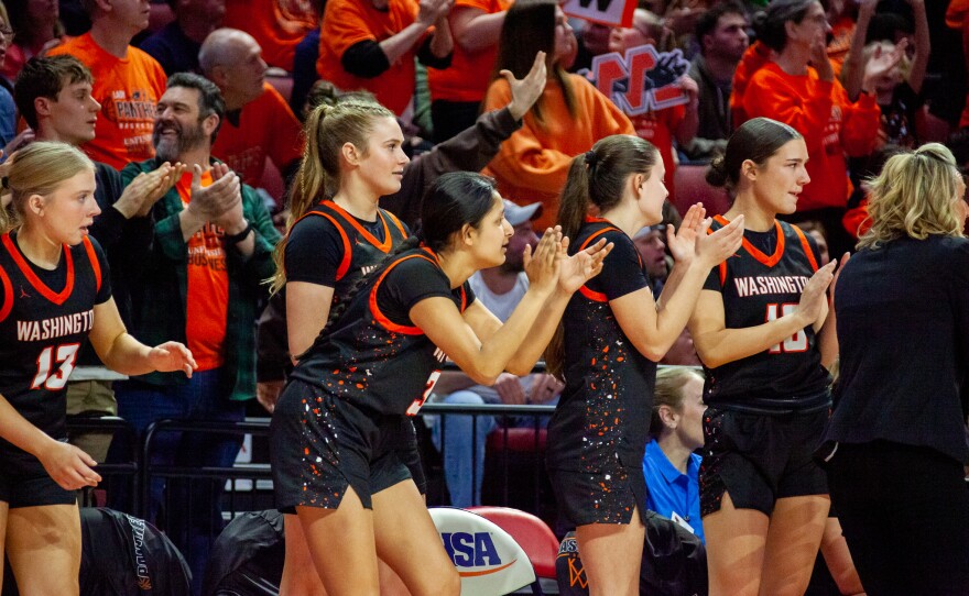 Girls high school basketball players inside an arena