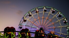 FILE: The sun drifts down, the lights ignite, and the ride lines begin to stretch as the first full night of the Woodstock Fair comes to life.
