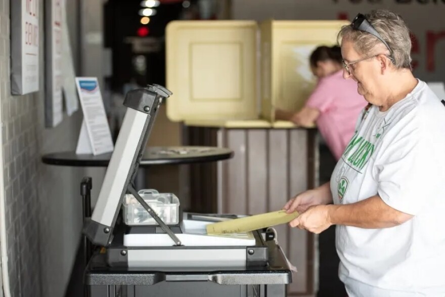 Lawton residents Brenda Russell feeds her ballot into a machine for the run-off election on Aug. 23, 2022. Russell and her mother were the only voters in the House District 62 polling station, which saw a low turnout that day according to poll workers.