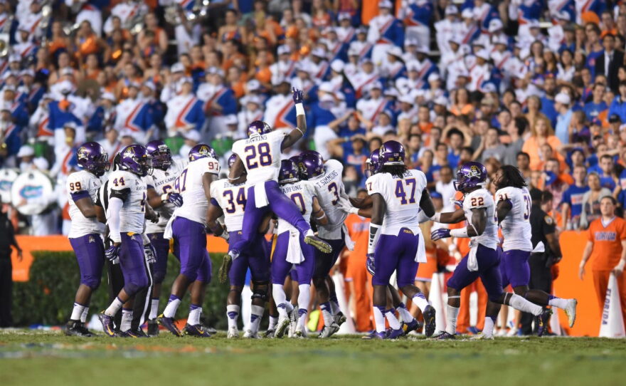East Carolina players celebrate after defensive back Bobby Fulp picks off Florida quarterback Will Grier.