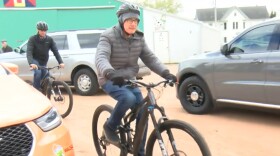 Governor Tony Evers rides a bike at Athens