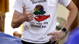 Jon Torsch, center, wears a T-shirt promoting democratic socialism during a gathering of the Southern Maine Democratic Socialists of America at City Hall in Portland, Maine, Monday, July 16, 2018. On the ground in dozens of states, there is new evidence that democratic socialism is taking hold as a significant force in Democratic politics. (Charles Krupa/AP)