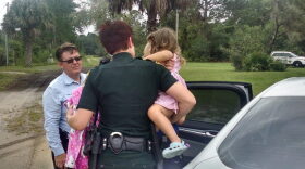 Captain Dominic Piscitello and Deputy Brandee Smith with Lilly Baumann.