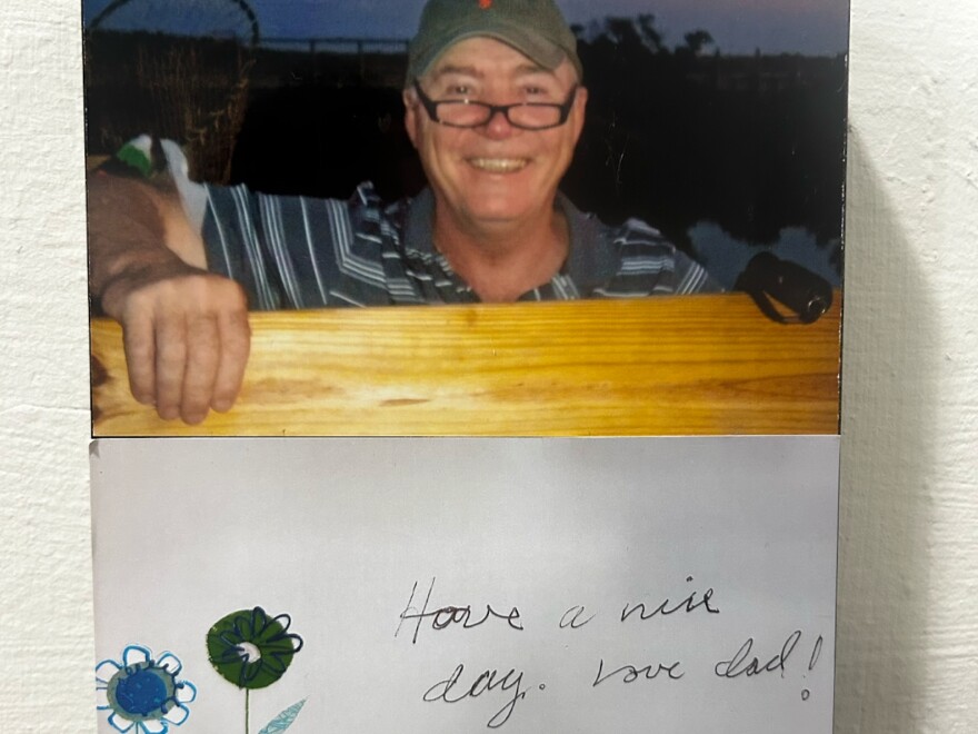Molly's dad smiling at the camera next to the note "Have a nice day, love Dad!"