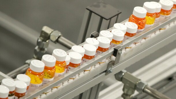 FILE- Bottles of medicine ride on a belt at a mail-in pharmacy warehouse in Florence, N.J., July 10, 2018. The Biden administration says the manufacturers of all of the first 10 prescription drugs it selected for Medicare’s first price negotiations have agreed to participate. Tuesday's announcement clears the way for talks that could lower their costs in coming years and gives the White House a potential political win heading into next year’s presidential election.  (AP Photo/Julio Cortez, File)