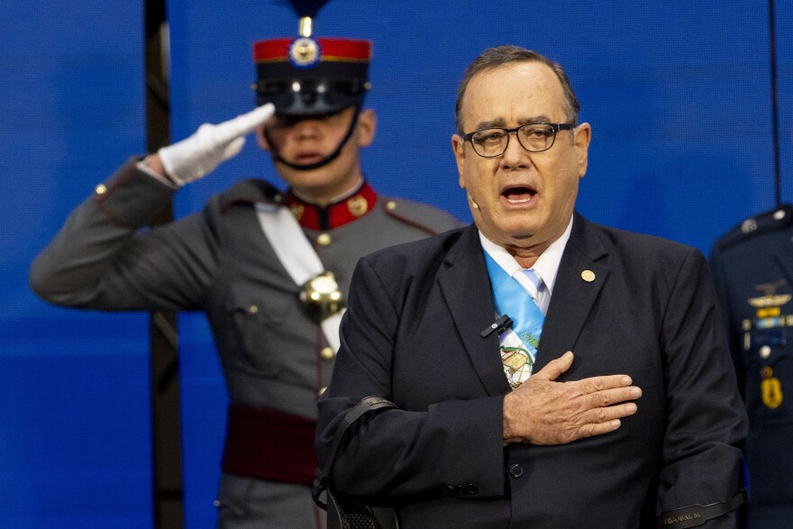 FILE - Guatemalan President Alejandro Giammattei sings the national anthem before giving his third annual address to the nation at the National Palace in Guatemala City, Jan. 14, 2023.