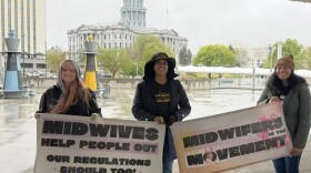 Elephant Circle staff and Colorado licensed professional midwives, (left to right) Heather Prestridge, Pia Long, and Justina Nazario, at the Colorado State Capitol on May 5, 2026. 