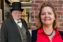 On the left is a man in a top hat and bow tie. On the right is a woman in a red shirt. 