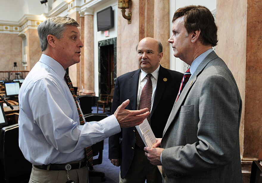 House Budget Committee Chair Rick Rand, D-Bedford (left), confers with House Majority Whip Tommy Thompson, D-Owensboro (right), and House Majority Caucus Chair Robert Damron, D-Nicholasville, prior to the start of the day's legislative session in the Kent