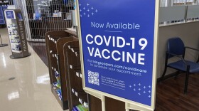 In this Oct. 23, 2021 photo, a sign notifies customers that COVID-19 vaccinations are available at a pharmacy in a grocery store in Monument, Colorado.