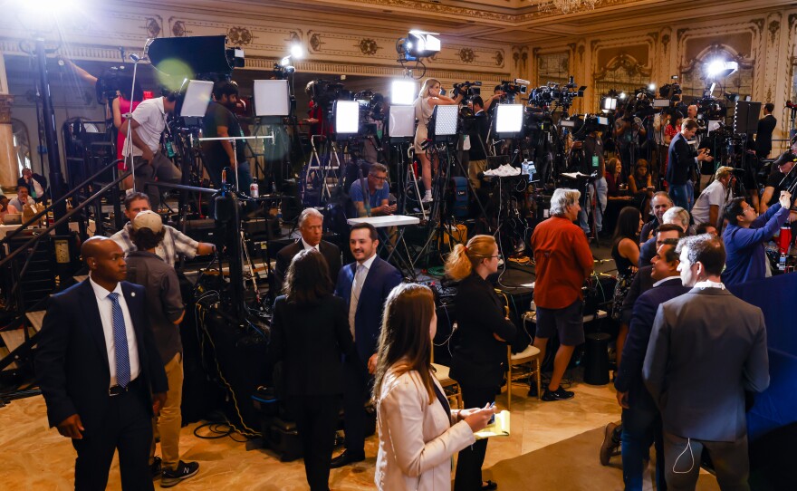 Members of the media wait for Trump to speak.