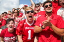 Cheering IU students wearing red in the student section at a football game