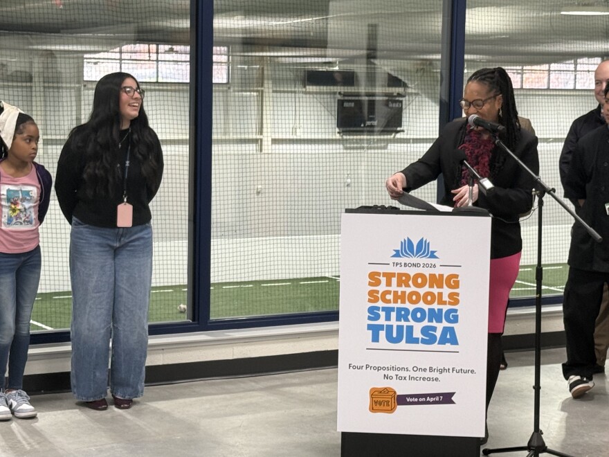 Tulsa Public Schools Superintendent Ebony Johnson and paraprofessional Victoria Timmons share a laugh during a press conference at Nathan Hale High School.