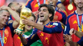 Spain’s Ferran Torres celebrates with the trophy after winning the World Cup final soccer match between Spain and Argentina in East Rutherford, N.J., near New York, Sunday, July 19, 2026.