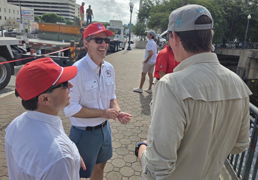 Texas Cavaliers' River Parade Marshal Alcide Longoria, center, talks with parade vice marshal, Andrew Himoff, left. and Tres Steves, right, captain of the guard for King Antonio, a member of Fiesta royalty