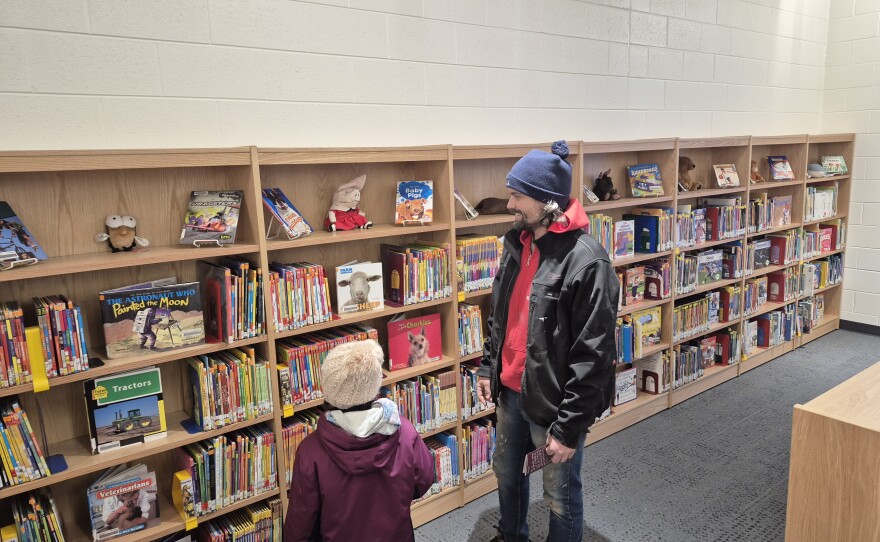 A parent and his daughter tour the Western Elementary School library during a Tuesday open house for first and fourth graders.