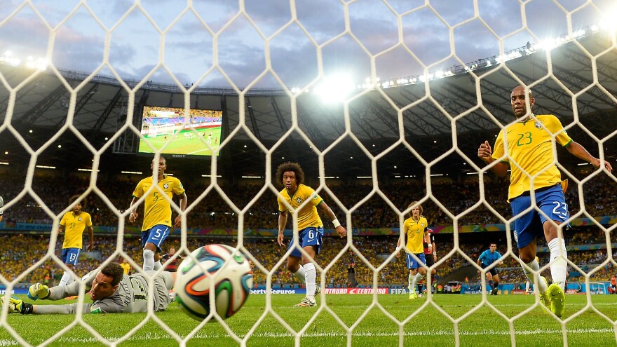 Brazilian goalkeeper Julio Cesar concedes a goal as his teammates look on during their 7-1 loss to Germany on Tuesday at the Mineirao Stadium in Belo Horizonte, Brazil.