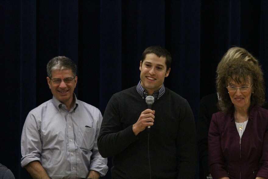 Paul Campbell addresses the assembly following his award. Mayor Ethan Berkowitz is to his right and Dr. Jane Foley is to his left. (Photo by Wesley Early, Alaska Public Media - Anchorage)