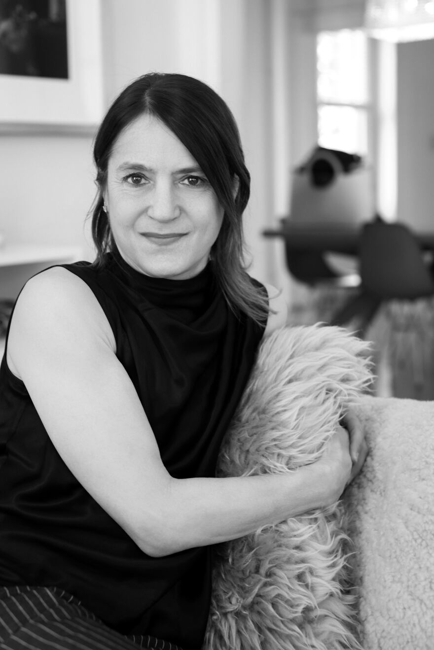 woman in a sleeveless blouse on a couch