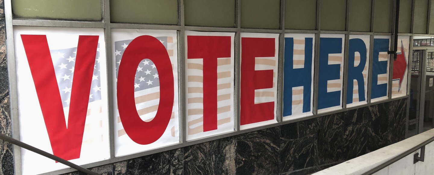 A "vote here" sign marks the entrance to an early voting station in downtown Minneapolis in 2018.