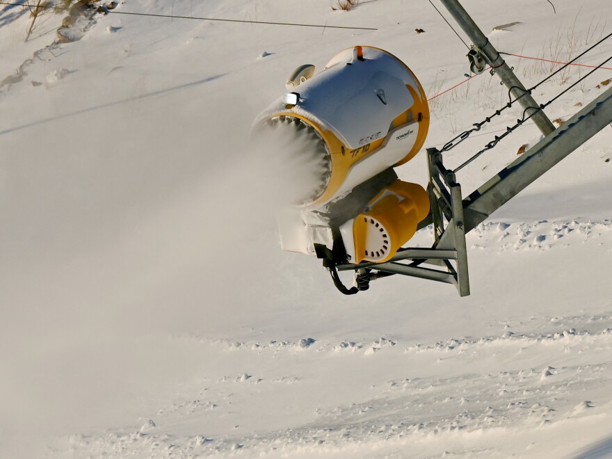 A snow machine spreads artificial snow at the National Alpine Skiing Center at the Beijing 2022 Winter Olympic Games.