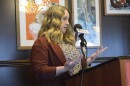 A woman speaks at a podium during a press conference