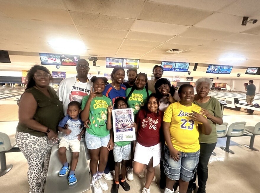 Corey Williams is surrounded by family at Friday’s Strike Out Cancer bowling event. Family and community members of all ages attended the memorial in support of Williams.