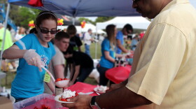 Kayla Gilligan, 11, serves strawberry shortcakes at the second annual Strawberry Festival in Ocala. Gilligan, who attends Howard Middle School, says volunteering for Habitat for Humanity is fun, knowing that it helps toward making a difference in the community she lives.