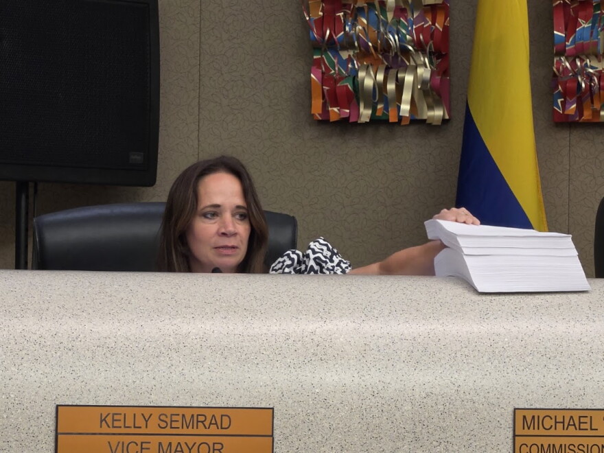 District 5 Kelly Martinez Semrad with a stack of nearly 2,000 petitions for a ban on large AI data centers.