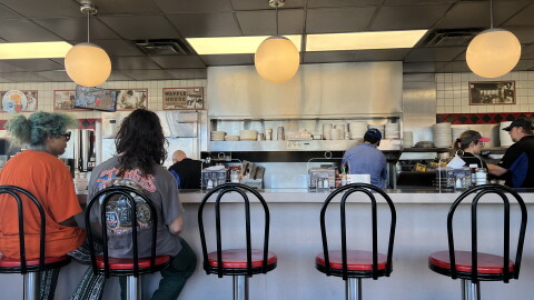 Customers wait for to-go orders at the Waffle House in Navarre after Hurricane Isaias.