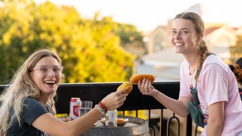 Attendees at 2024's Waco Restaurant Week Glizzfest "toast" the event with their unlimited hotdogs.