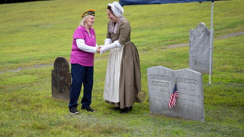 Doris Backus, left, of Sharon, Vt., shakes hands with Kristin Harris, Research Coordinator at the Boston Tea Party Ships & Museum, after placing a marker on the grave of Anthony Morse, a Boston Tea Party Participant, at Pine Hill Cemetery in Sharon, Vt., on Monday, Aug. 17, 2026. Backus, who is the cemetery's president and the fourth great granddaughter of Morse, helped to place the marker. "It meant a lot," Morse said of the experience. "I never thought I would've found something like this." (Valley News photo)