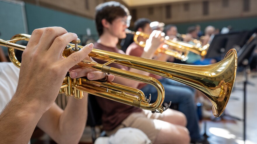 A close up of a brass instrument being played.