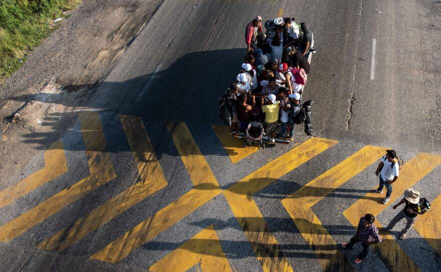 Migrants headed to the U.S. ride on a truck on the road from La Ventosa to Matias Romero, Oaxaca state, Mexico, on Thursday.