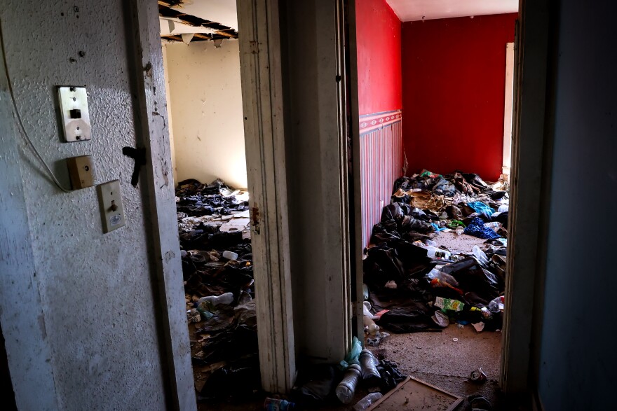 Backpacks, water bottles and clothing are littered in an abandoned ranch used as a stash house by human smugglers Thursday, April 10, 2025, outside of Crystal City.