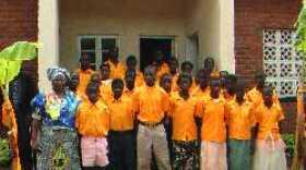 Mai (Mama) Deborah Naybor Building and new students of the first ever secondary school in Dumasi, Malawi, Africa, and founder of the Joyce Banda Foundation School, Mrs. Joyce Banda.