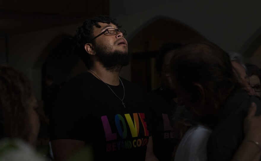 Tyler Reckard cries while attending the funeral service for his grandmother, Margie Reckard, Friday in El Paso.