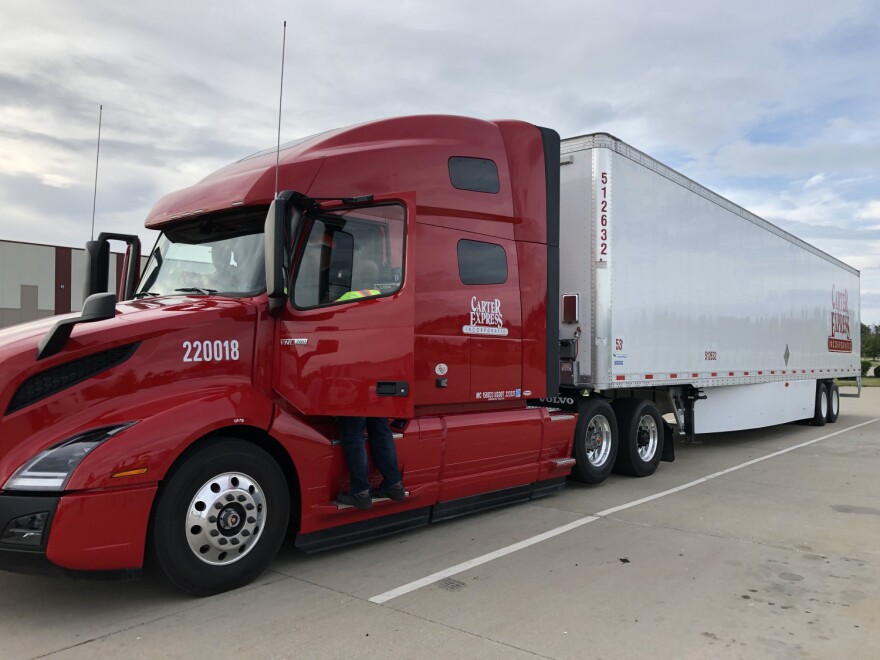 A trooper prepares for a police detail in a semi truck.