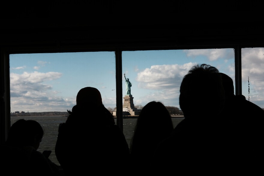 People look out at the Statue of Liberty, which has remained open during the shutdown, on January 6.