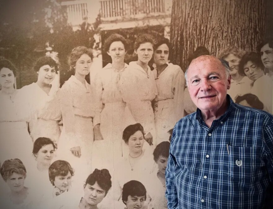 Mansfield Female College museum director Van Reech stands before a historic image of the school’s former students.