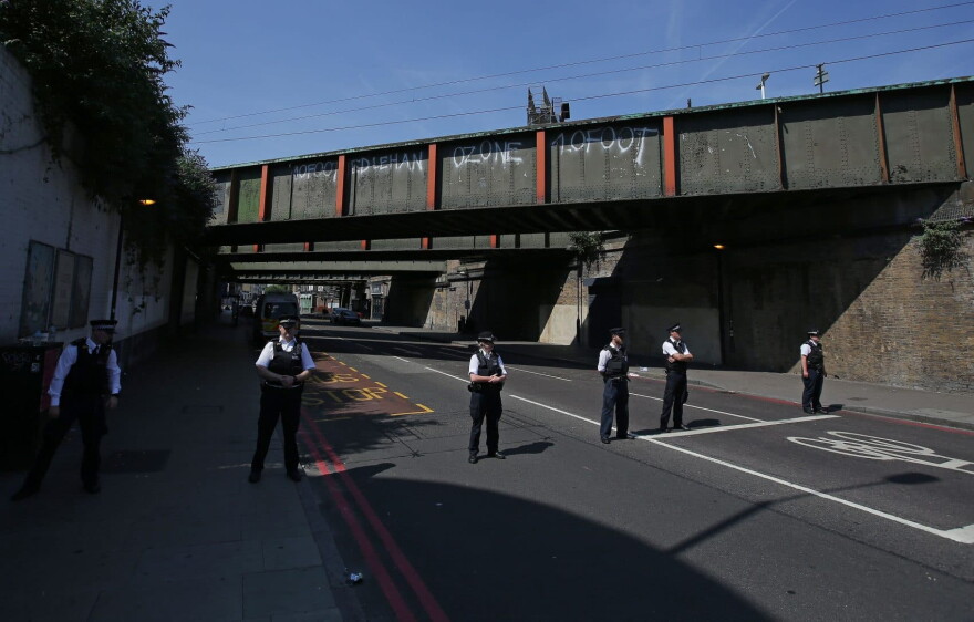 Police stand on duty inside a police cordon in the Finsbury Park area of north London, June 19, 2017, after a vehicle was driven into pedestrians. (Daniel Leal-Olivas/AFP/Getty Images)