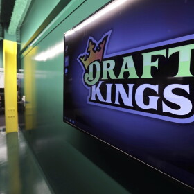 Large DraftKings logo is displayed on a wall