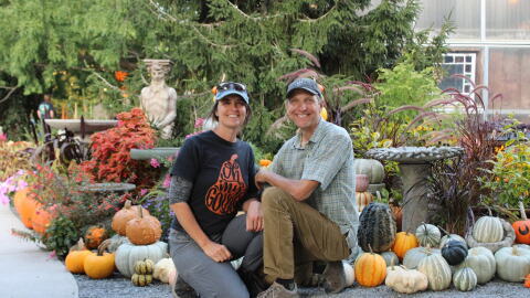Sherri and Kevin Kukuchka, owners of Creekside Gardens, kneel in front of the entrance of the Pumpkin Walk. The annual event brings hundreds of families to Tunkhannock to see the pumpkin display.