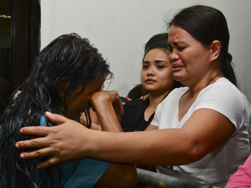 A survivor cries as she arrives at hospital in Cebu after a ferry collided with a cargo ship in Cebu, central Philippines on Friday.