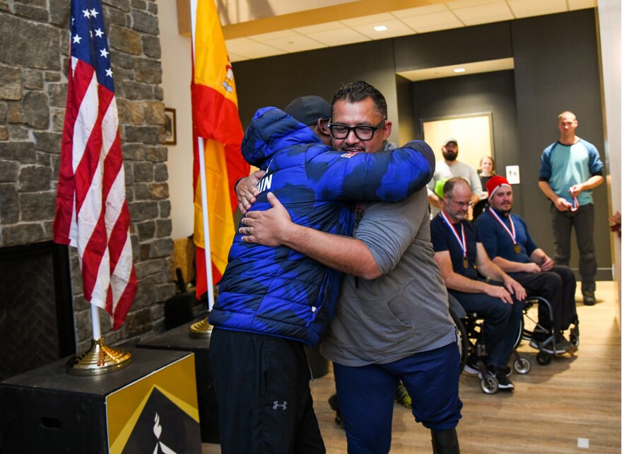 Team U.S.A.'s Guillermo 'Will' Castillo, right, gives Team Great Britain's Corie Mapp, a hug as goes up to accept his gold medal after taking first place for the first day of the Para Bobsled World Cup competition during an award ceremony concluding the World Cup race at Mt. Van Hoevenberg in Lake Placid, N.Y., Sunday, November 20, 2022.