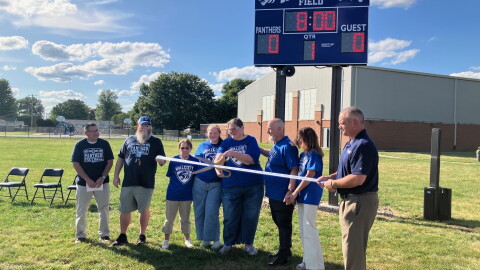 Members of the Dennis Johns family take part in a ribbon-cutting at the Walcott School football field, naming it for the late coach, on Thursday, Sept. 10, 2026.