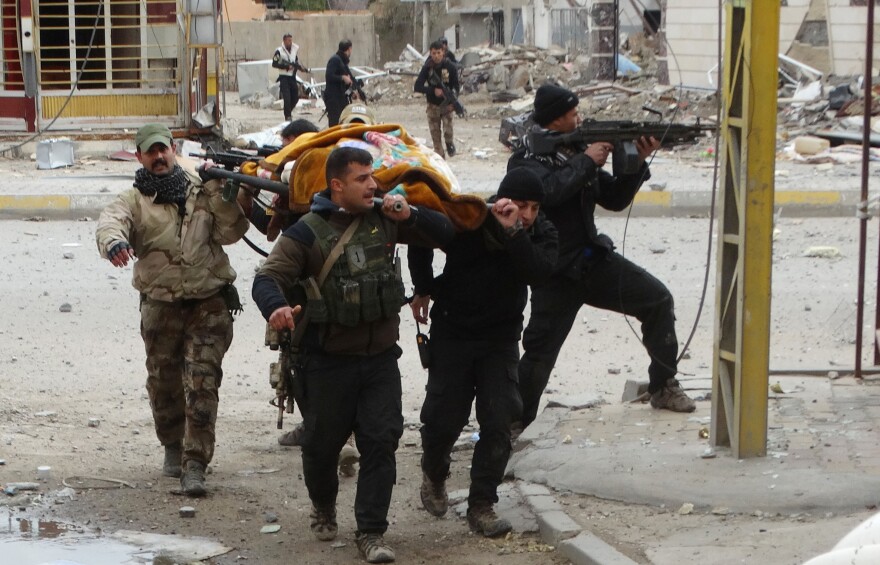 Iraqi security forces and allied Sunni tribal fighters evacuate an injured woman after she was shot by the Islamic State in Ramadi on Jan. 4. Iraqi forces have pushed ISIS out of much of Ramadi, but daily fighting is still taking place in the southeast part of the city, where ISIS is using civilians as human shields, according to the Iraqi military.