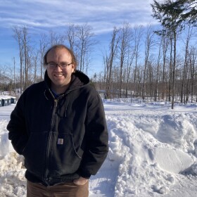 Neil Haney at Lake Louise Christian Community in Boyne Falls. The nonprofit has factored logging revenues into its budget for decades and salvage harvested much of its timber after the ice storm. Haney is worried that harvest may have seriously complicated the organization's eligibility for federal assistance to restore the forest. (Photo: Ellie Katz/IPR News)