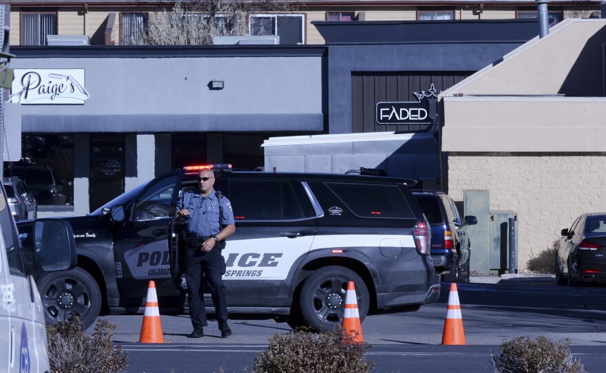 A police officer monitors the scene near Club Q in Colorado Springs, Colo. early Sunday morning.