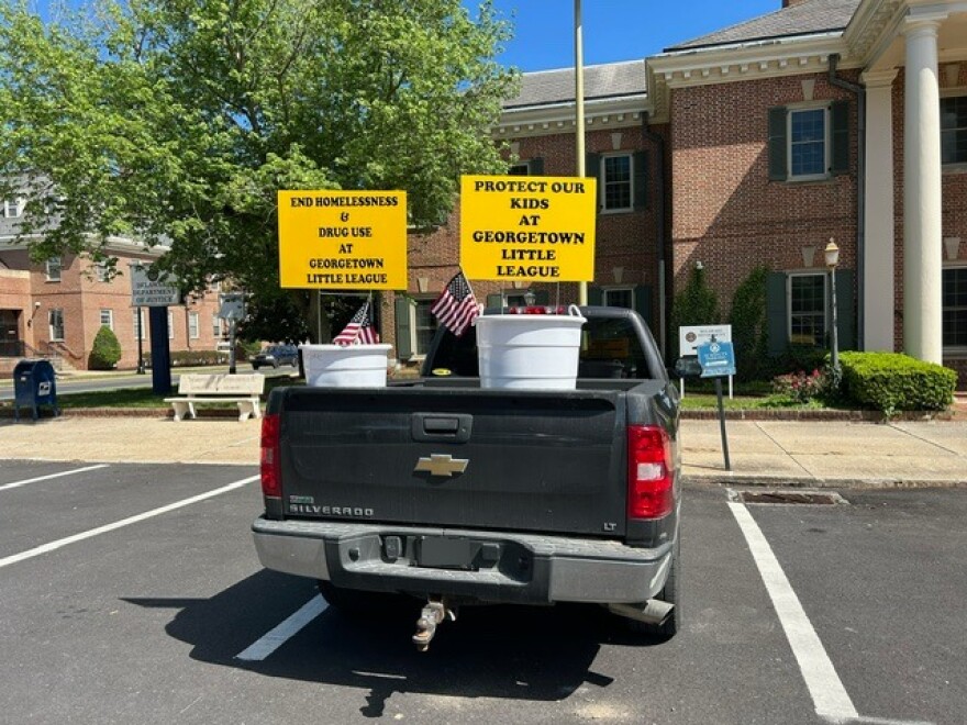 A parked truck with a sign supporting the end of homelessness, among other things, in Georgetown.